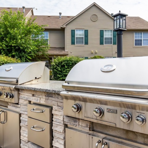 Two  outdoor grills with counterspace