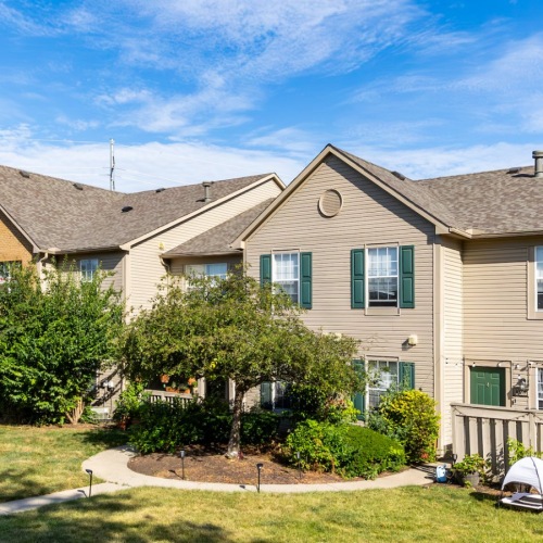 Exterior of apartments with mulched greenery. 